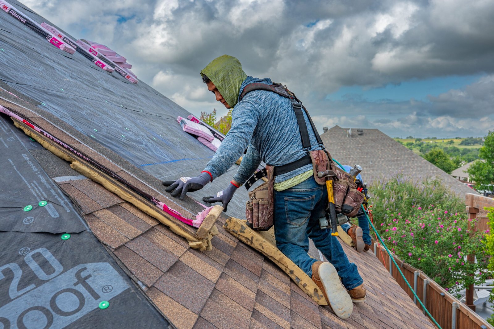 Roofer installing shingles on a roof